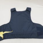 Tummansininen suojaliivi, joka on rikkoutunut vasemmassa alakulmasta.